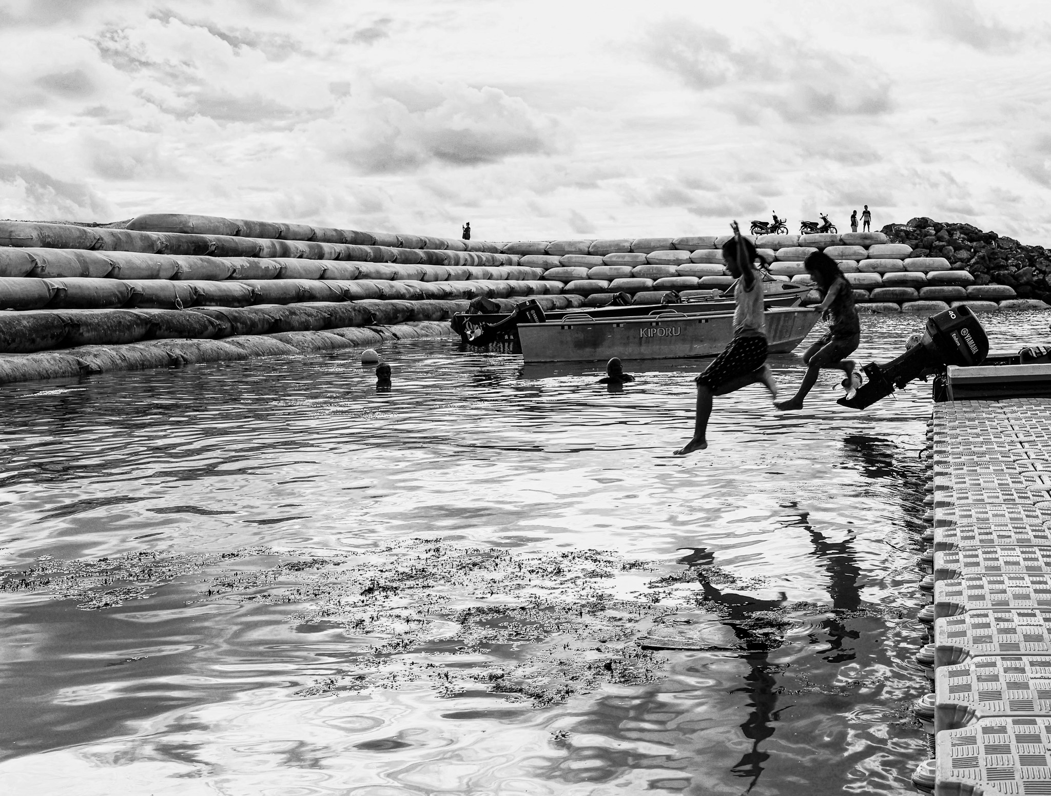 Children playing in floodwater at the Tuvalu land reclamation site
